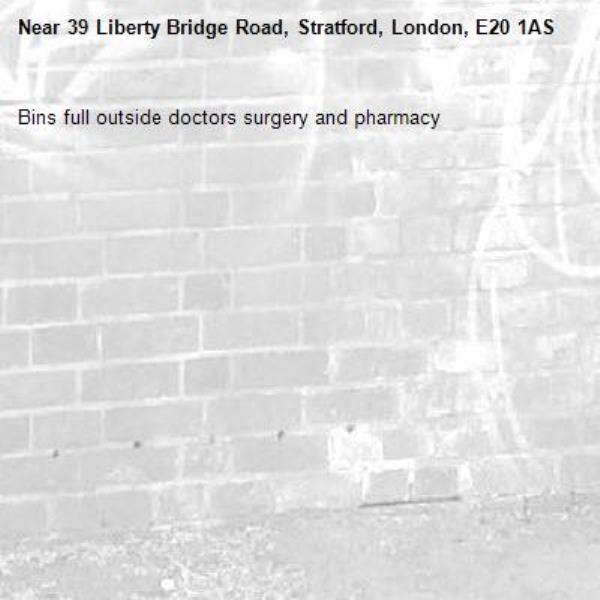 Bins full outside doctors surgery and pharmacy -39 Liberty Bridge Road, Stratford, London, E20 1AS
