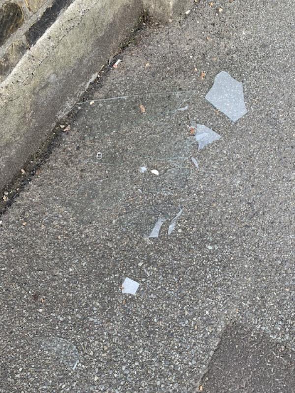Shattered glass on pedestrian footpath. Manor Park at junction to Lee High Rd, SE13. Please clear for safety. Thank you! -Manor Park, London