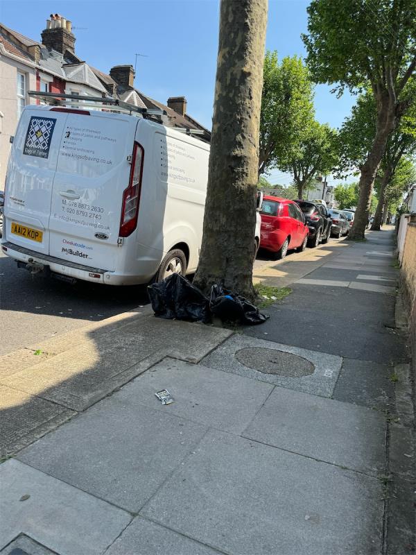 Two black bags left under the tree outside 70 Third Avenue -70 Third Avenue, Manor Park, London, E12 6DU