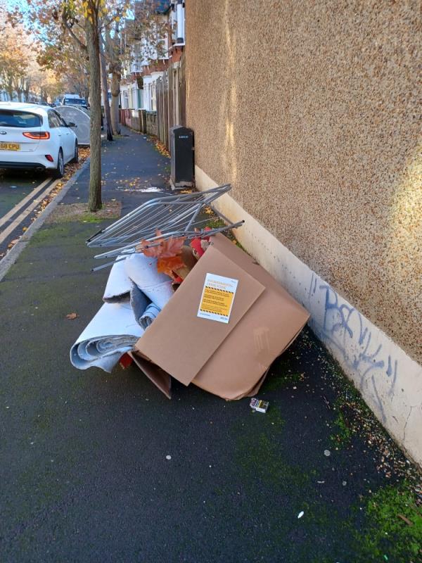 Cardboard box containing carpets and clothes hanger fly tipped at 51 Crofton Road, E13. -51 Crofton Road, Plaistow, London, E13 8QT