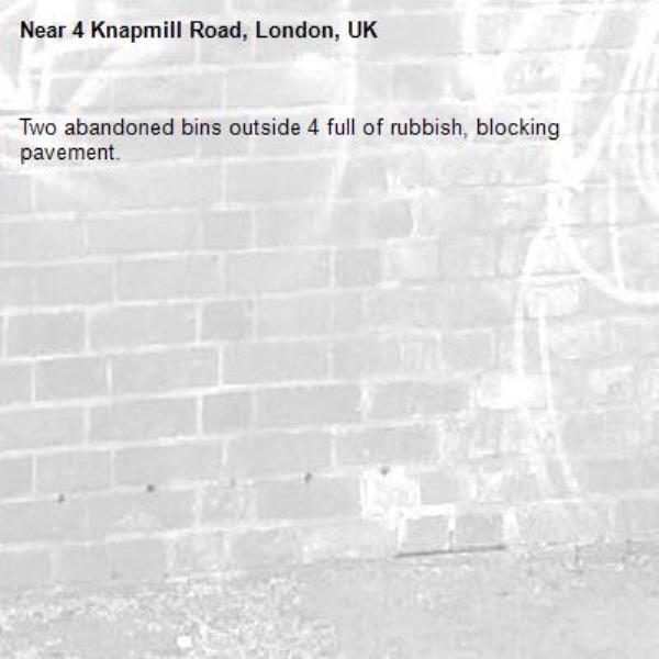 Two abandoned bins outside 4 full of rubbish, blocking pavement.-4 Knapmill Road, London, UK