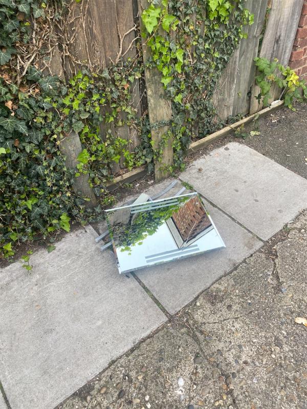 Mirror dumped on pavement -Play Space