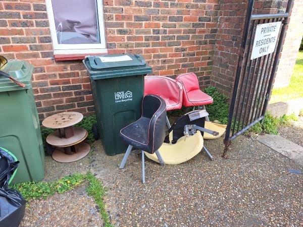 Chairs and wooden  wire spools dumped by the gates of Thornton Court.-Thornton Court, Bourne Street, Eastbourne, BN21 3RX
