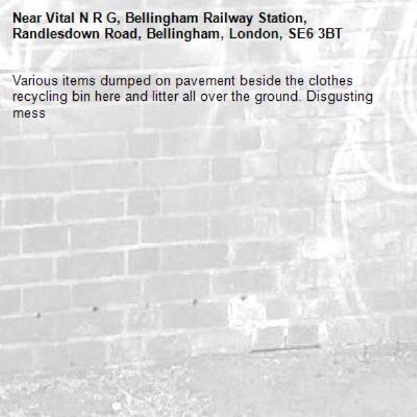 Various items dumped on pavement beside the clothes recycling bin here and litter all over the ground. Disgusting mess-Vital N R G, Bellingham Railway Station, Randlesdown Road, Bellingham, London, SE6 3BT