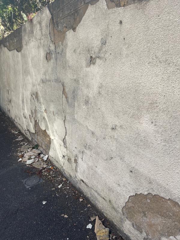 Wall crumbling sharp debris on pavement dangerous -85 Ham Park Road, London, E15 4AD