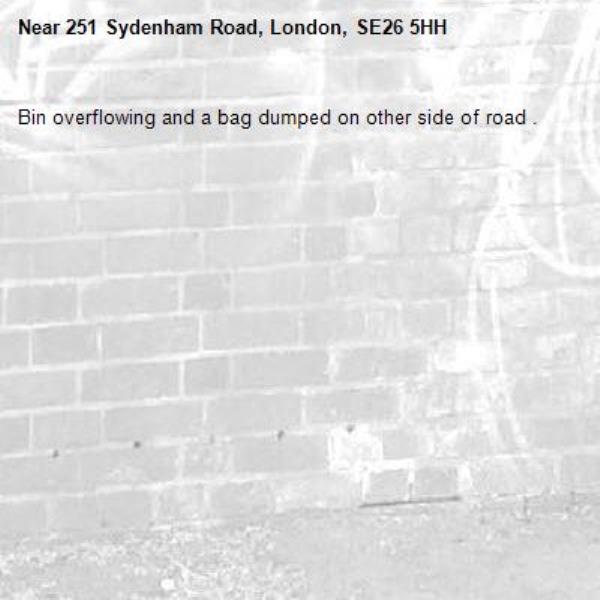 Bin overflowing and a bag dumped on other side of road .-251 Sydenham Road, London, SE26 5HH