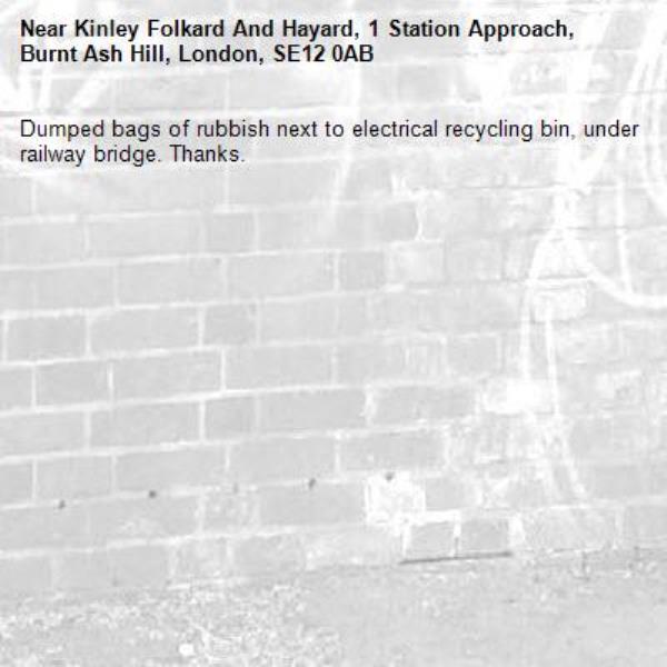 Dumped bags of rubbish next to electrical recycling bin, under railway bridge. Thanks.-Kinley Folkard And Hayard, 1 Station Approach, Burnt Ash Hill, London, SE12 0AB