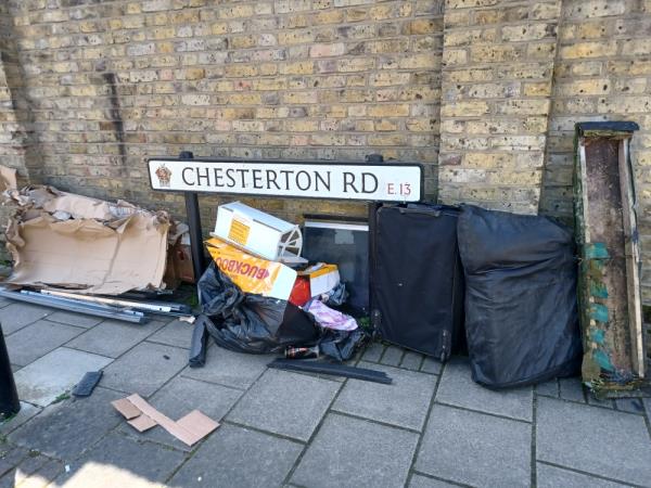 Cardboard boxes, sofa, suitcase and metal poles fly tipped at 99 Chesterton Road, E13. -99 Chesterton Road, Plaistow, London, E13 8BD