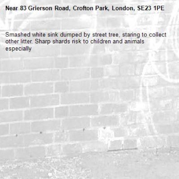 Smashed white sink dumped by street tree, staring to collect other litter. Sharp shards risk to children and animals especially -83 Grierson Road, Crofton Park, London, SE23 1PE