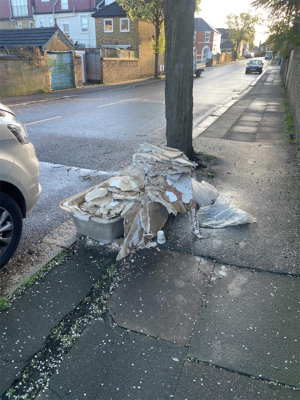 Plasterers tub and plaster board dumped on pavement.-Dowanhill Road, London