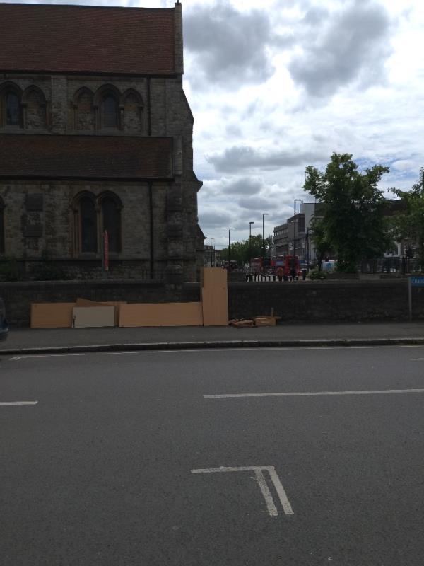 Flat pack furniture dumped against church wall.-31d Lewisham High Street, London, SE13 5AF