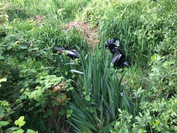 Downham Playing Fields between Glenbow Road entrance and Pavalion. Motor bike dumped on embankment -92 Rangefield Road, Bromley, BR1 4RQ