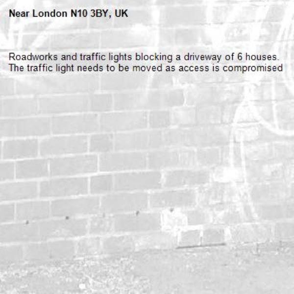 Roadworks and traffic lights blocking a driveway of 6 houses. The traffic light needs to be moved as access is compromised-London N10 3BY, UK