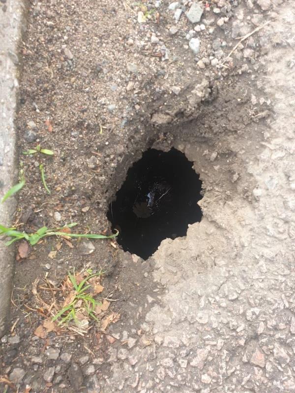 Pothole has appeared outside the entrance of Wolsey house primary school and is above the street drainage system. The hole is large enough for a child’s foot to go down. -75 Beaumont Leys Lane, Mowmacre Hill, LE4 2BB, England, United Kingdom