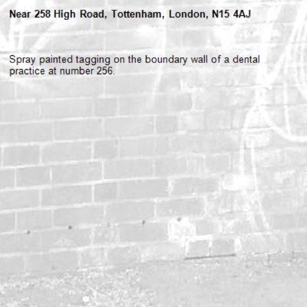Spray painted tagging on the boundary wall of a dental practice at number 256.-258 High Road, Tottenham, London, N15 4AJ