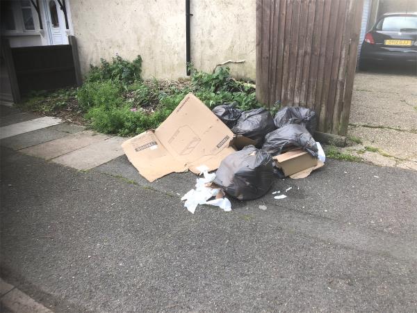 Please clear bags and boxes from by garages-41 Luffman Road, Grove Park, London, SE12 9SZ