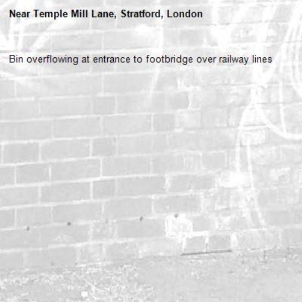 Bin overflowing at entrance to footbridge over railway lines -Temple Mill Lane, Stratford, London