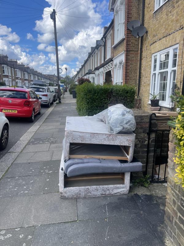 Bed frame and building waste on kerb for weeks. -67 Merritt road