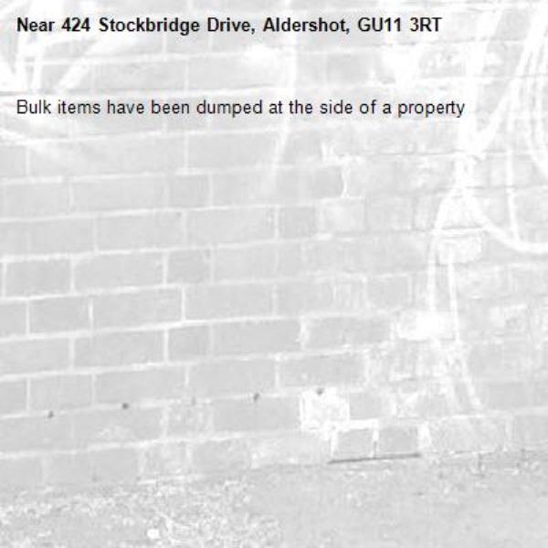Bulk items have been dumped at the side of a property -424 Stockbridge Drive, Aldershot, GU11 3RT