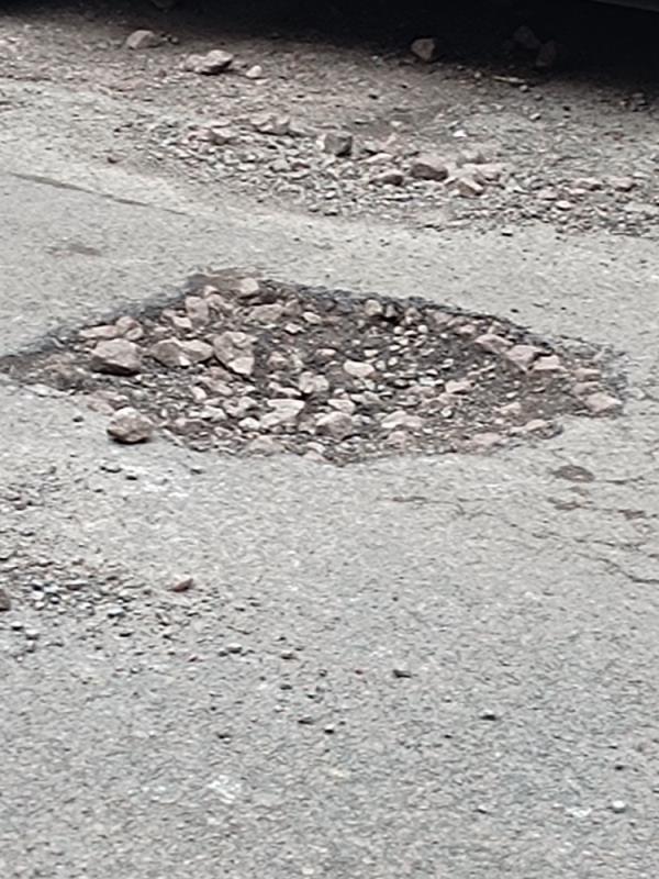 The hole is getting bigger and rocks are all over the road -92 Kimberley Road, Leicester, LE2 1LG