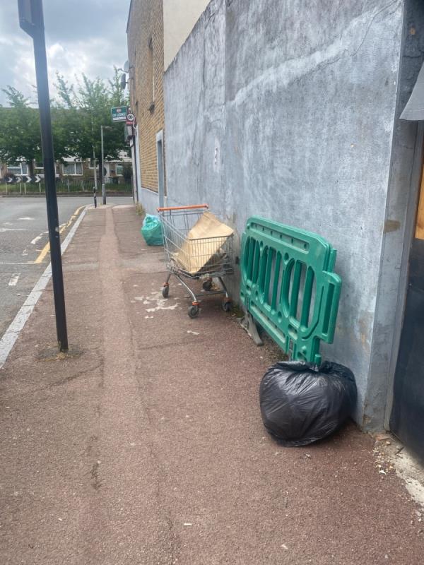Rubbish bags barriers and shopping trolley what a mess this road is-12 Buckingham Road, London, E15 1SW