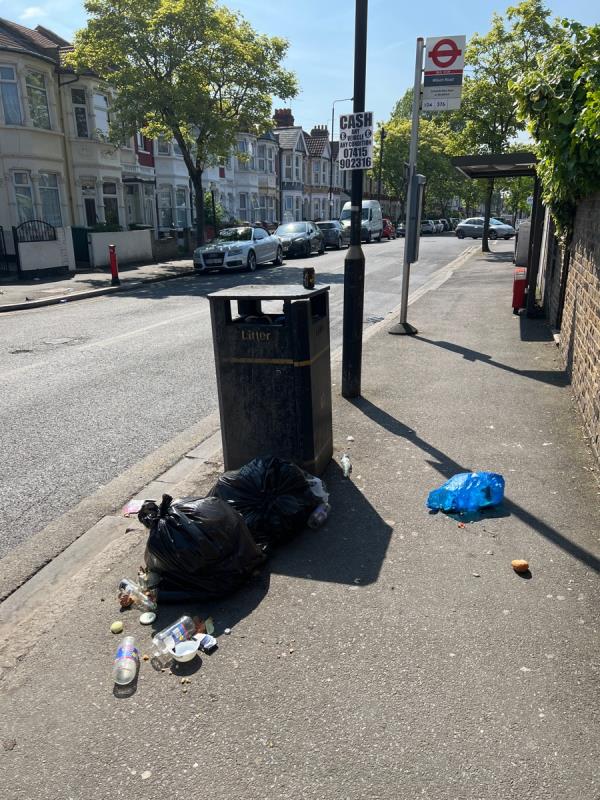 Multiple black bags of household food waste left by bus stop on boundary Road. Food spilling onto street and attracting vermin.-87 Boundary Road, Plaistow, London, E13 9PT