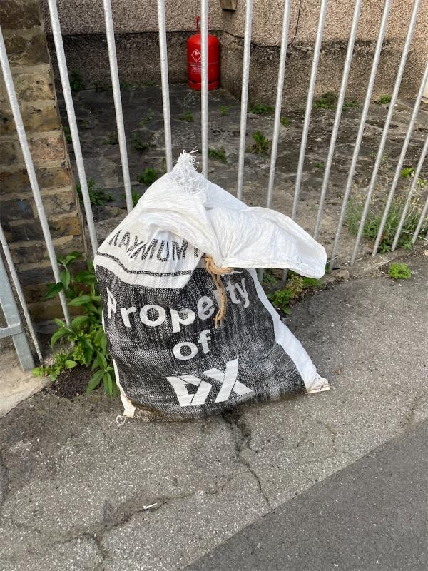 Dumped building waste in DX delivery bag-40 Wildfell Road, London, SE6 4HU