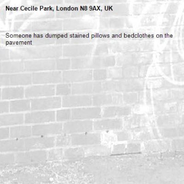 Someone has dumped stained pillows and bedclothes on the pavement-Cecile Park, London N8 9AX, UK