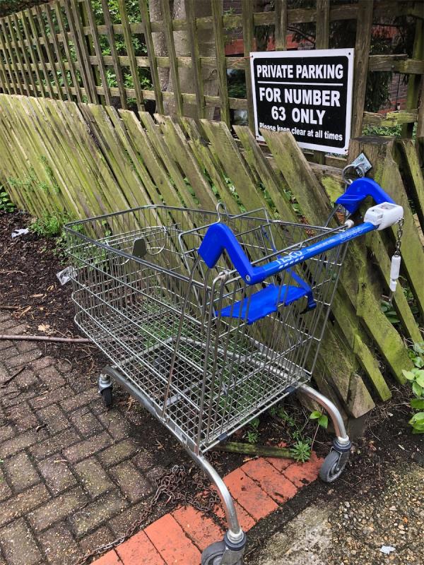 Please clear an Abandoned Tesco trolley from parking area-7 Rosewood Gardens, Lewisham, London, SE13 7NQ