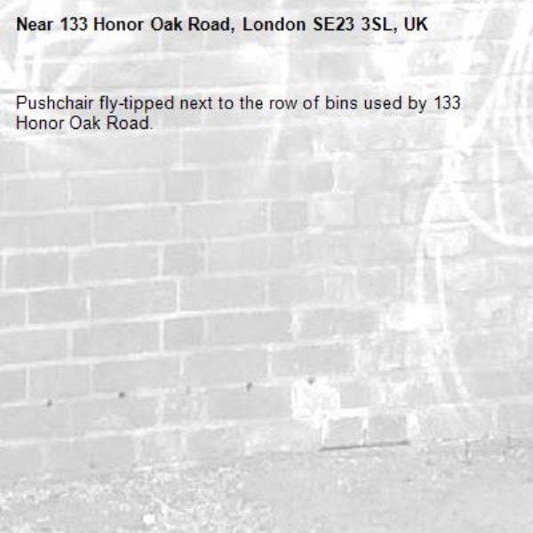 Pushchair fly-tipped next to the row of bins used by 133 Honor Oak Road.-133 Honor Oak Road, London SE23 3SL, UK