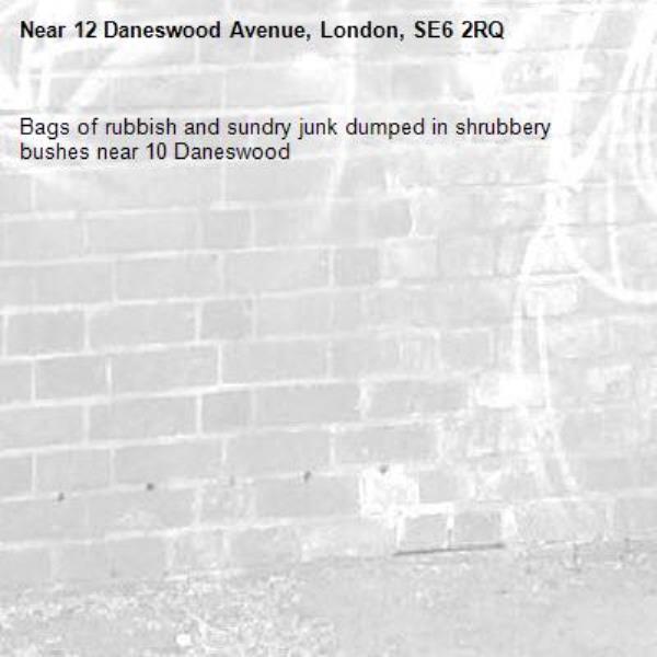 Bags of rubbish and sundry junk dumped in shrubbery bushes near 10 Daneswood -12 Daneswood Avenue, London, SE6 2RQ