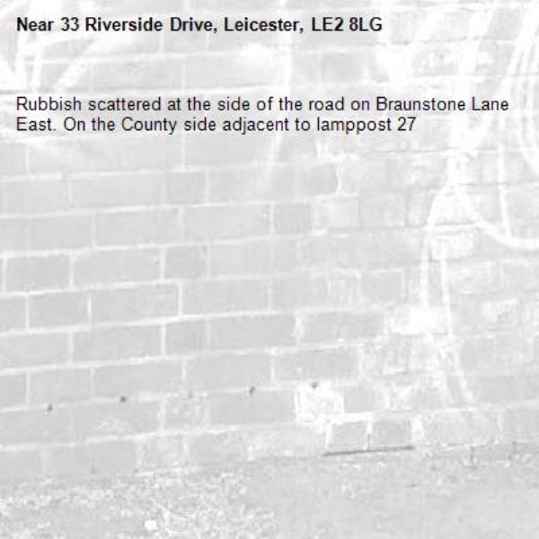 Rubbish scattered at the side of the road on Braunstone Lane East. On the County side adjacent to lamppost 27-33 Riverside Drive, Leicester, LE2 8LG