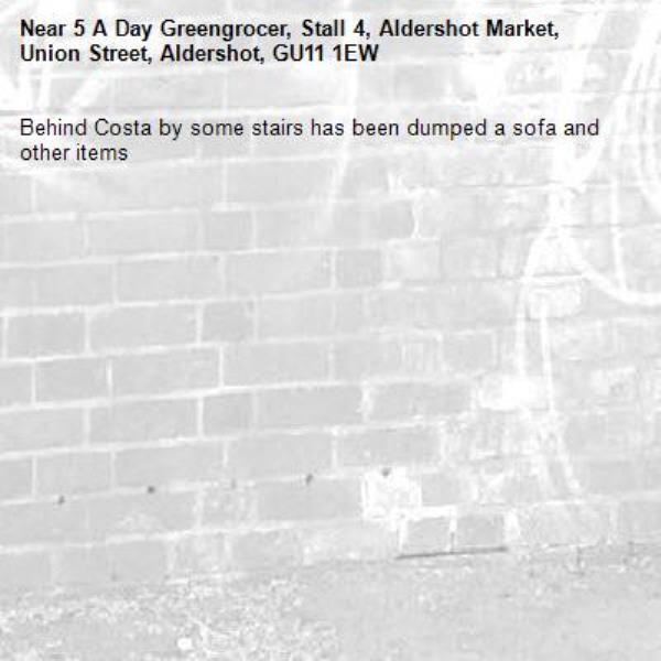 Behind Costa by some stairs has been dumped a sofa and other items -5 A Day Greengrocer, Stall 4, Aldershot Market, Union Street, Aldershot, GU11 1EW