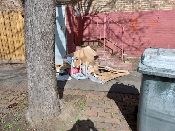 Cardboard boxes, plastic tub, gas cylinders and wooden table fly tipped outside 13 Lawson Close, E16. -13 Lawson Close, West Beckton, London, E16 3JS