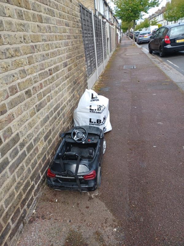 Toy car and household waste fly tipped at junction of 225 Central Park Road and Hockley Avenue, E6. -225 Central Park Road, East Ham, London, E6 3AE