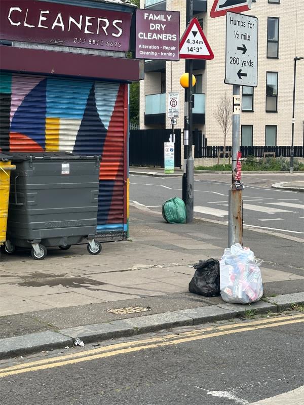 Opened bin bags on the pavement -85 Oakdale Road, Tottenham, London, N4 1NU