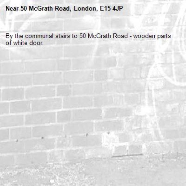 By the communal stairs to 50 McGrath Road - wooden parts of white door.-50 McGrath Road, London, E15 4JP