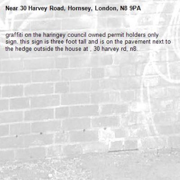 graffiti on the haringey council owned permit holders only sign. this sign is three foot tall and is on the pavement next to the hedge outside the house at , 30 harvey rd, n8. -30 Harvey Road, Hornsey, London, N8 9PA