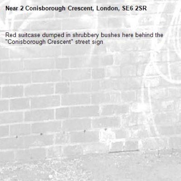 Red suitcase dumped in shrubbery bushes here behind the "Conisborough Crescent" street sign-2 Conisborough Crescent, London, SE6 2SR