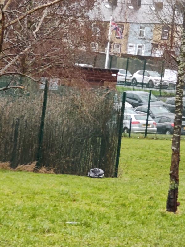 Black bag by the school fence -54 Queensberry Road, BB11 4LH, England, United Kingdom
