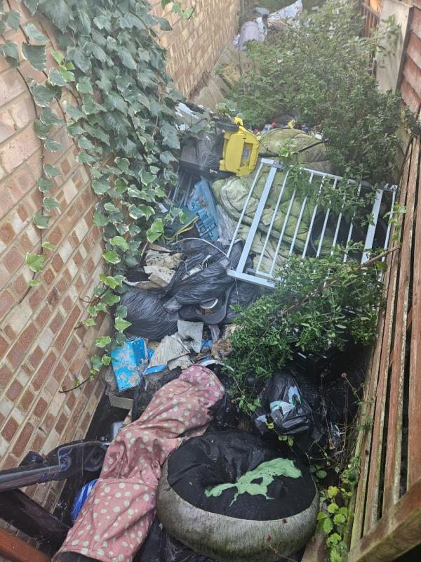 Rubbish left behind properties by previous tenant of Holly Road. Access is via alley way next to 176 Holly Road and this alley continues after a left turn to 184 Holly Road, there is rubbish throughout.-184 Holly Road
