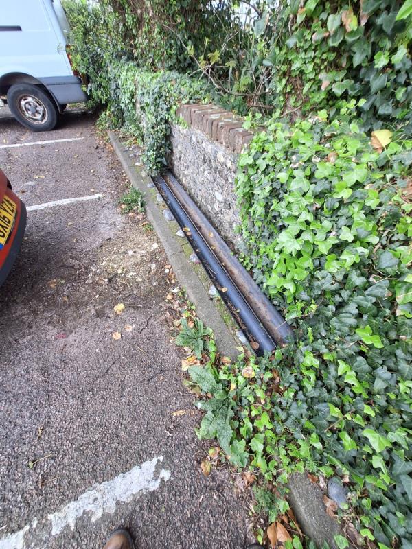 Plastic guttering in lower place car park along the flint wall. Sent by Andy Strickland Neighbourhood First Advisor 07710066443-Essex Mews, Essex Place, Newhaven, BN9 9BJ