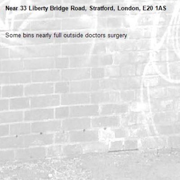 Some bins nearly full outside doctors surgery -33 Liberty Bridge Road, Stratford, London, E20 1AS