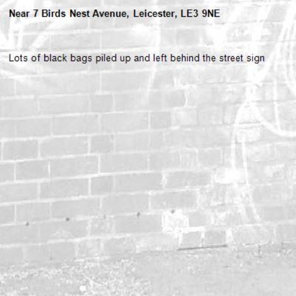 Lots of black bags piled up and left behind the street sign-7 Birds Nest Avenue, Leicester, LE3 9NE