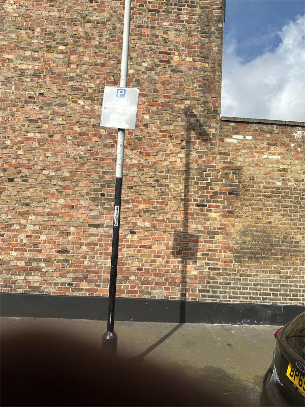 Parking sign being sprayed over and removed from the pole-Palmerston Road, Forest Gate, London