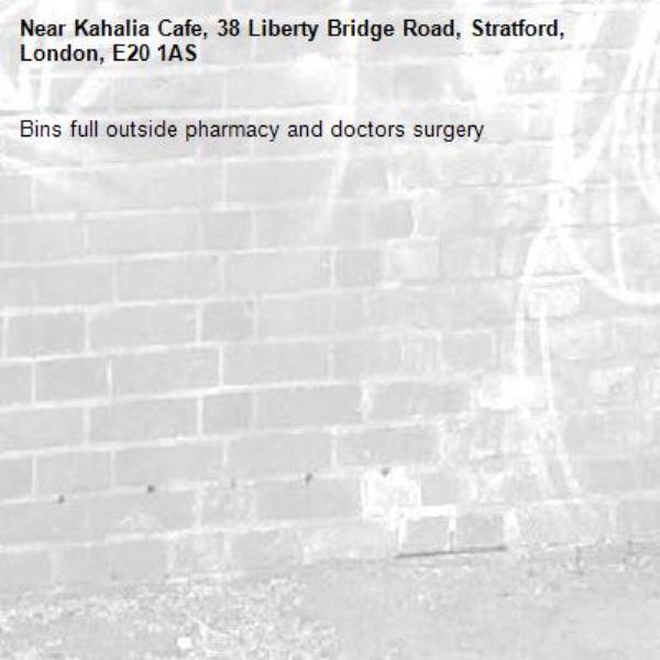Bins full outside pharmacy and doctors surgery -Kahalia Cafe, 38 Liberty Bridge Road, Stratford, London, E20 1AS