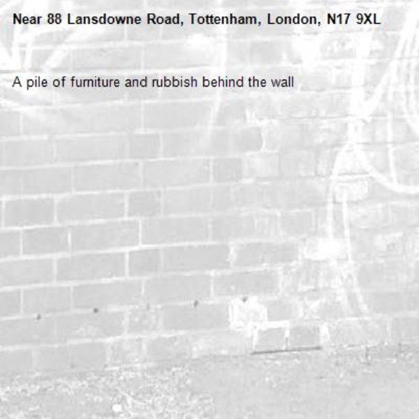 A pile of furniture and rubbish behind the wall -88 Lansdowne Road, Tottenham, London, N17 9XL