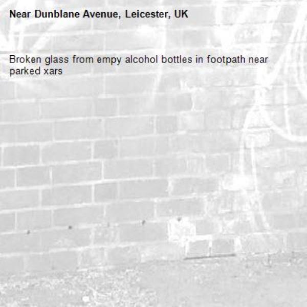 Broken glass from empy alcohol bottles in footpath near parked xars-Dunblane Avenue, Leicester, UK