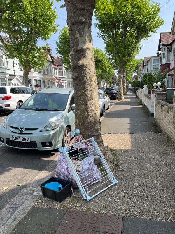 Household waste left under a tree on Cotswold Gardens-27 Cotswold Gardens, East Ham, London, E6 3HZ