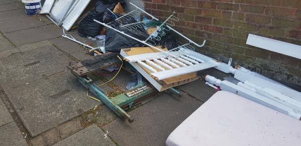 This has been over 2 weeks, causing inconvenience to adults, children, pushchair users. Left on  pavement at the top of the road. Sharp objects- hazardous for young children and families and elderly people.  Wooden objects, small objects, need it urgently removed asap. Sharp debris -105 Vulcan Road, Leicester, LE5 3EE